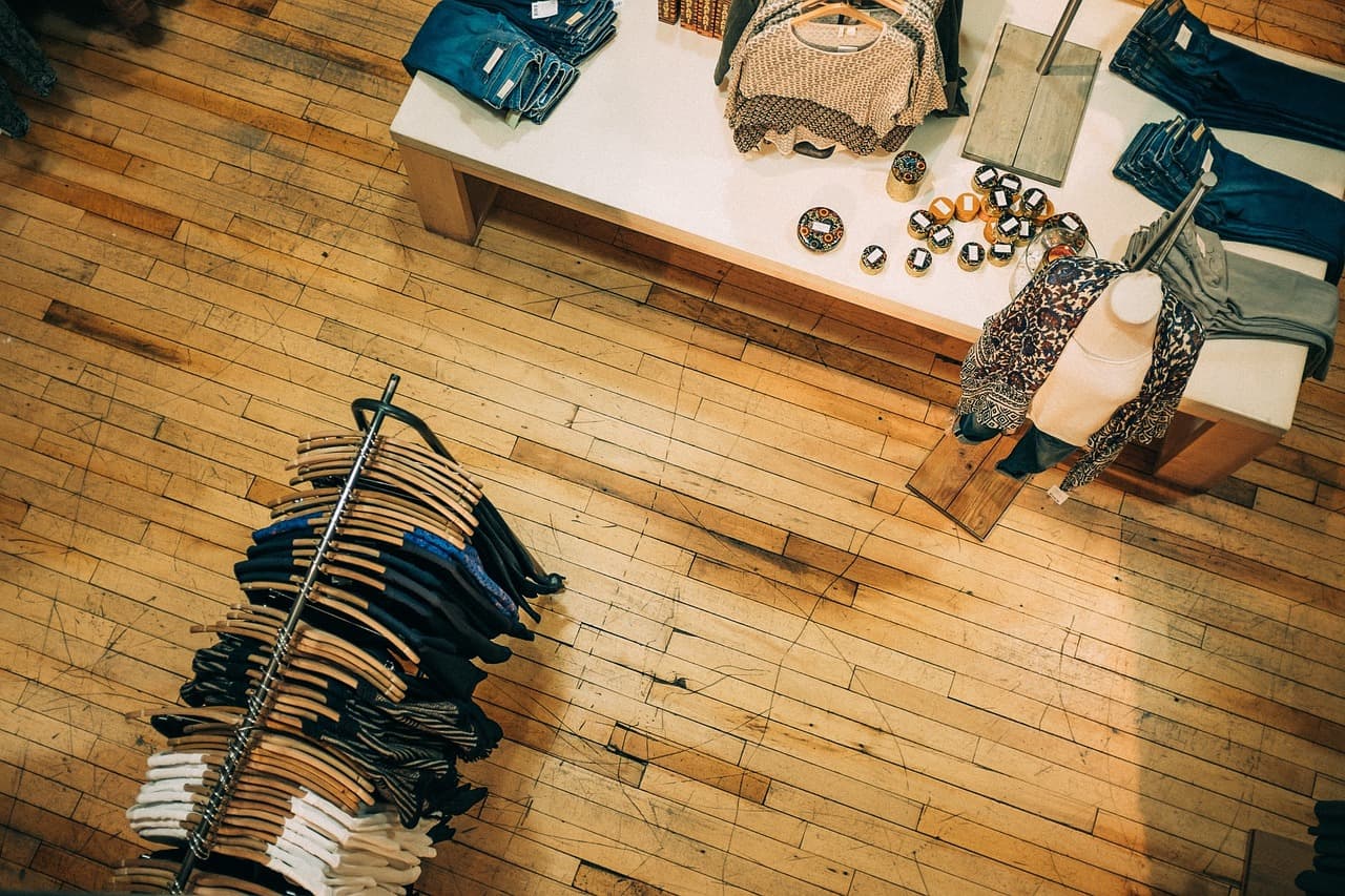 Overhead view of folded clothing and accessories on display in a retail store