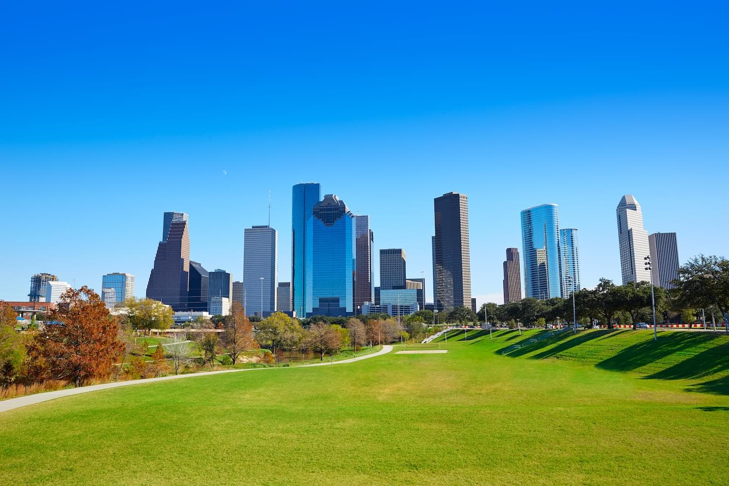 The downtown Houston skyline seen from a green park