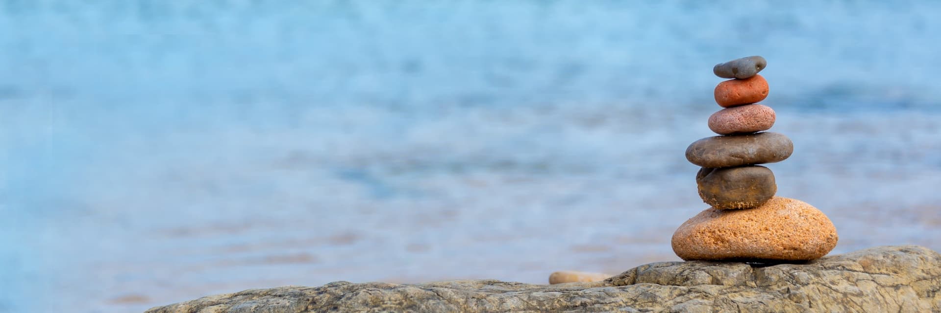 A stack of balanced stones on a rocky beach