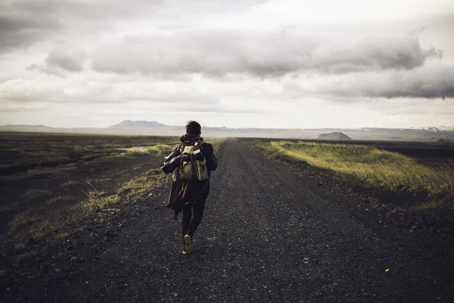 A lone adventurer at the top of a mountain ridge